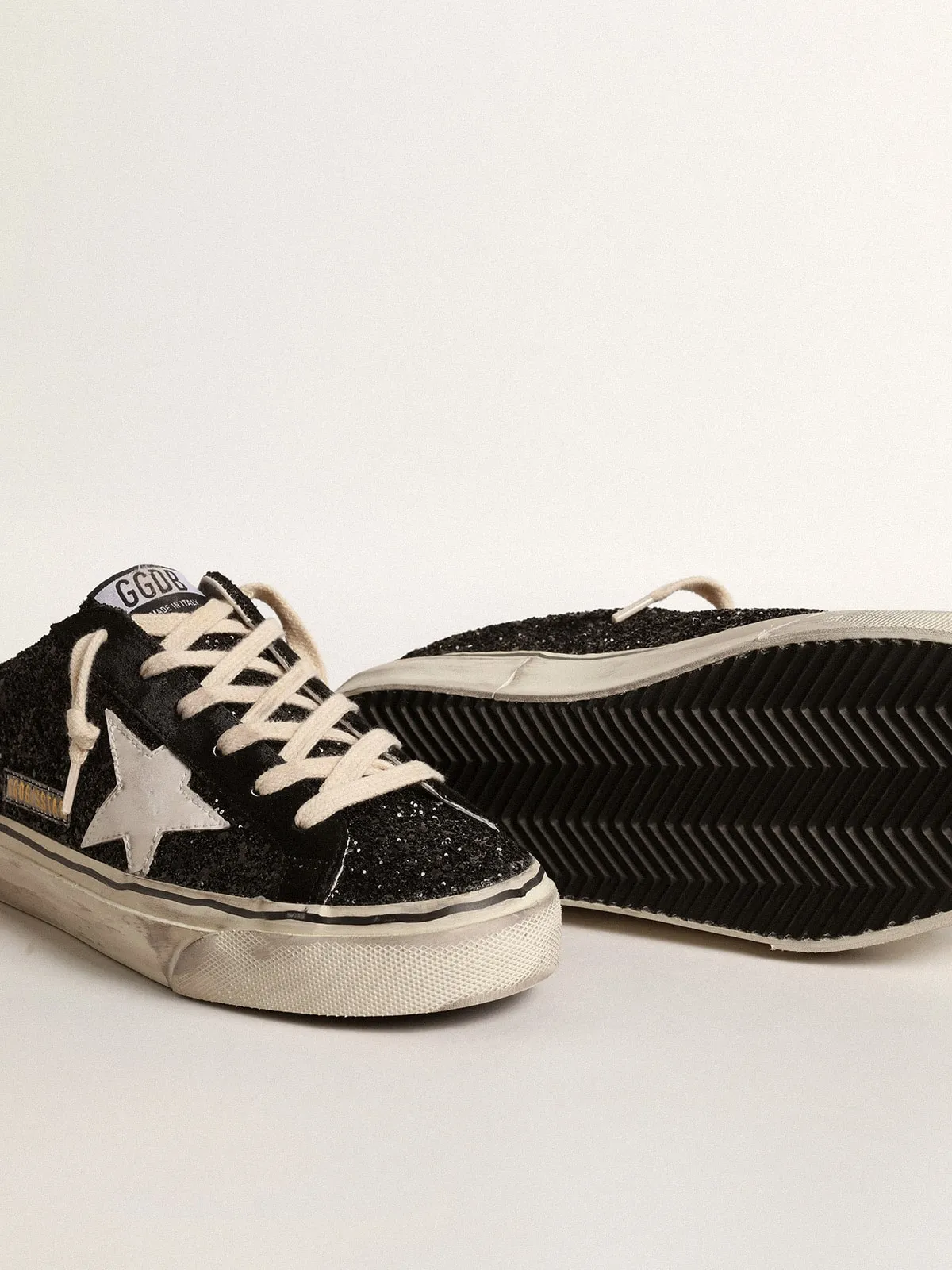 Super-Star Sabot in glitter neri con stella bio-based bianca
